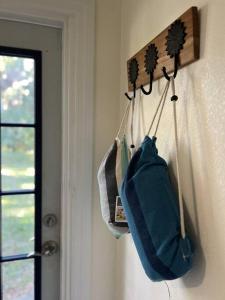 two bags hanging on a wall next to a window at Country Welcome in Micanopy