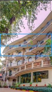 a large building with balconies on the side of it at Blue Flamingo Goa Apartment-Casa-Baga in Baga
