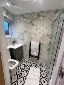 La salle de bains est pourvue d'une douche, de toilettes et d'un lavabo. dans l'établissement Lovely Relaxing One Bedroom Flat, à Royal Tunbridge Wells