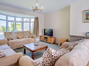 a living room with two couches and a tv at 4 Bed in Shanklin IC068 in Shanklin