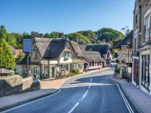 an empty street in a small town with thatched roofs at 4 Bed in Shanklin IC068 in Shanklin