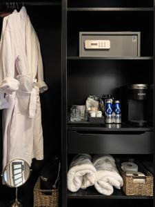 a shelf with towels and other items in a closet at Carnegie House in State College