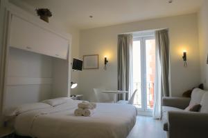 a hotel room with two beds with a teddy bear on it at Estudios Plaza Comendadora in Madrid