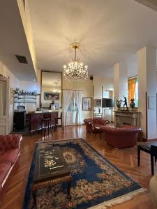 a living room with a chandelier and a living room at Hotel Petit Royal in Ospedaletti