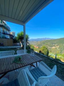 a patio with a table and chairs and a view at Apartment in Seborga with a fantastic view in Seborga