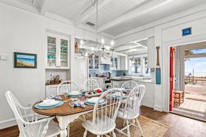 a kitchen and dining room with a table and chairs at Salty Sister - 302 in Anna Maria