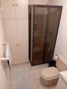 a bathroom with a toilet and a glass shower at Hermosa Habitación en Av Arce frente a Multicine in La Paz