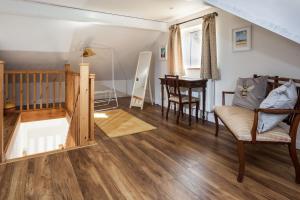 a living room with a staircase and a table at The Sunset Retreat in Banbury