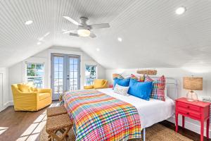 a bedroom with a bed and a ceiling fan at Salty Sister - 302 in Anna Maria