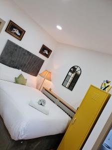 a bedroom with a bed with a yellow door at SureBillionaire Homes II in London