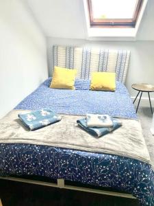 a bed with two pillows on it in a room at Central st Leonard’s Maisonette in St. Leonards