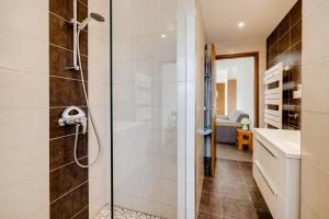 a shower with a glass door in a bathroom at SARL HARTWEG Les Amandiers in Beblenheim +44 photos
