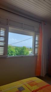 Postel nebo postele na pokoji v ubytování F2 Vue sur mer La villa du manguier