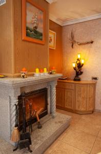 a living room with a stone fireplace in a room at Casa rural Valtravieso in Las Navas del Marqués +14 photos