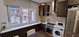 a small kitchen with a sink and a microwave at Mina La Camocha · 2 Hab · 4 pax · Wifi in Gijón