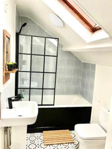 a bathroom with a sink and a bath tub at Central st Leonard’s Maisonette in St. Leonards