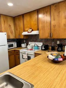 a kitchen with wooden cabinets and a wooden counter top at Exciting 2 B/1 b near FSU /FAMU. in Tallahassee