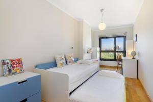 a bedroom with two beds and a window at Spacious 2BR apartment with free parking in Lisbon by Soulplaces in Lisbon
