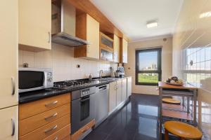 a kitchen with stainless steel appliances and a window at Spacious 2BR apartment with free parking in Lisbon by Soulplaces in Lisbon