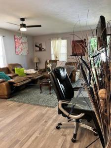 a living room with a chair and a glass table at Exciting 2 B/1 b near FSU /FAMU. in Tallahassee