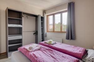 two beds sitting next to each other in a room at SARL HARTWEG Les Amandiers in Beblenheim