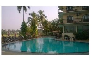 a large swimming pool in front of a building at Blue Flamingo Goa Apartment-Casa-Baga in Baga