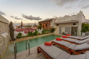 a villa with a swimming pool and a house at Hotel Noi Cartagena 1860 in Cartagena de Indias