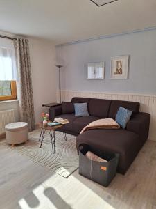 a living room with a couch and a table at Ferienwohnung Tintemann in Traben-Trarbach