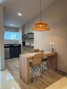 a kitchen with a table and chairs and a light fixture at Hotel Buena Vista in Bucaramanga