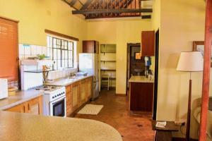 a kitchen with a stove and a refrigerator at Mabuda Guest Farm in Stegi