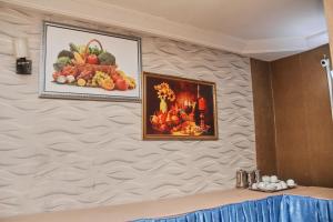 duas fotos de frutas e legumes em uma parede em GLAMOUR PARK'S HOTEL, ABUJA em Abuja