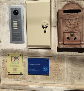 a telephone and a box on the side of a wall at Iris apartments in Monopoli