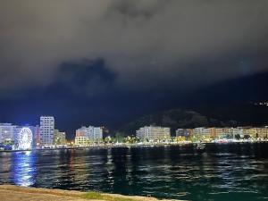 - Vistas a la ciudad por la noche desde el agua en Kristeo en Vlorë