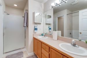 a bathroom with two sinks and a shower at 12 Mi to DIA Cozy Denver Townhome with Fireplace! in Aurora +23 photos