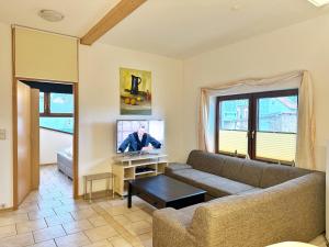 a living room with a couch and a tv at Ferienwohnungen Stadtmitte in Sassnitz