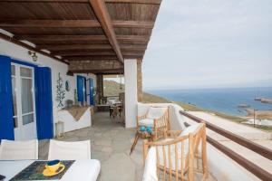 a patio with a view of the ocean at Apt with Amazing Balcony View of Mykonos in Agios Sostis Mykonos