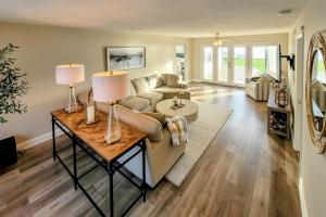 a living room with a couch and a table with lamps at Benton Harbor Lake House with Dock and Fire Pit! in Woodland Beach