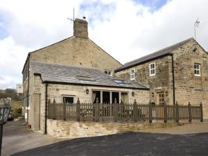 an old brick building with a wooden fence at 1 Bed in Pateley Bridge G0015 in Pateley Bridge