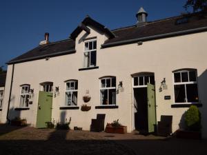 a white house with green doors and windows at 2 Bed in Knaresborough HH075 in Knaresborough