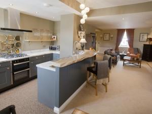 a kitchen with a large island and a living room at 1 Bed in Pateley Bridge G0026 in Pateley Bridge
