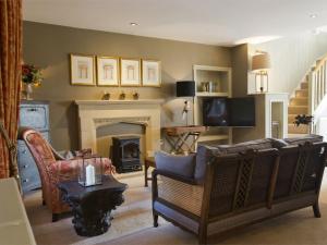 a living room with a couch and a fireplace at 1 Bed in Pateley Bridge G0026 in Pateley Bridge