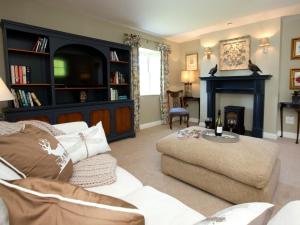 a living room with a couch and a fireplace at 1 Bed in Pateley Bridge G0050 in Pateley Bridge