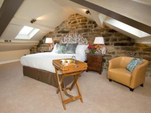 a bedroom with a bed and a chair and a table at 1 Bed in Pateley Bridge G0050 in Pateley Bridge