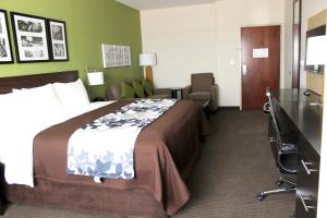 A bed or beds in a room at Sleep Inn & Suites