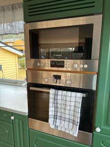 a kitchen with a oven with a towel on it at House close to Ålesund center in Ålesund