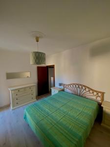 a bedroom with a bed and a dresser in it at Casina del Mare in Cecina