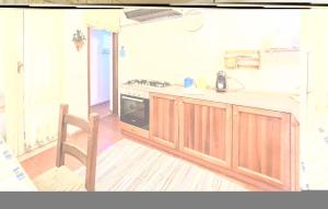 a kitchen with a stove and a chair in it at Villa Antica in Stalettì