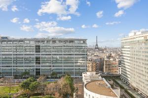 a view of a city with tall buildings at Paris luxury Apartment with Eiffel Tower View, 1 min metro, parking in Paris
