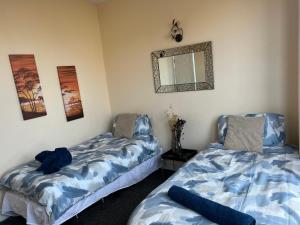 two beds sitting next to each other in a room at Winter Gardens Large Flat 1 in Blackpool