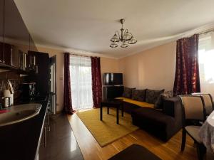 a living room with a couch and a table at Apartament Słoneczny in Ustka